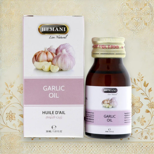 Hemani Knoblauchöl Flasche neben Originalverpackung mit Knoblauchgrafik – 30 ml